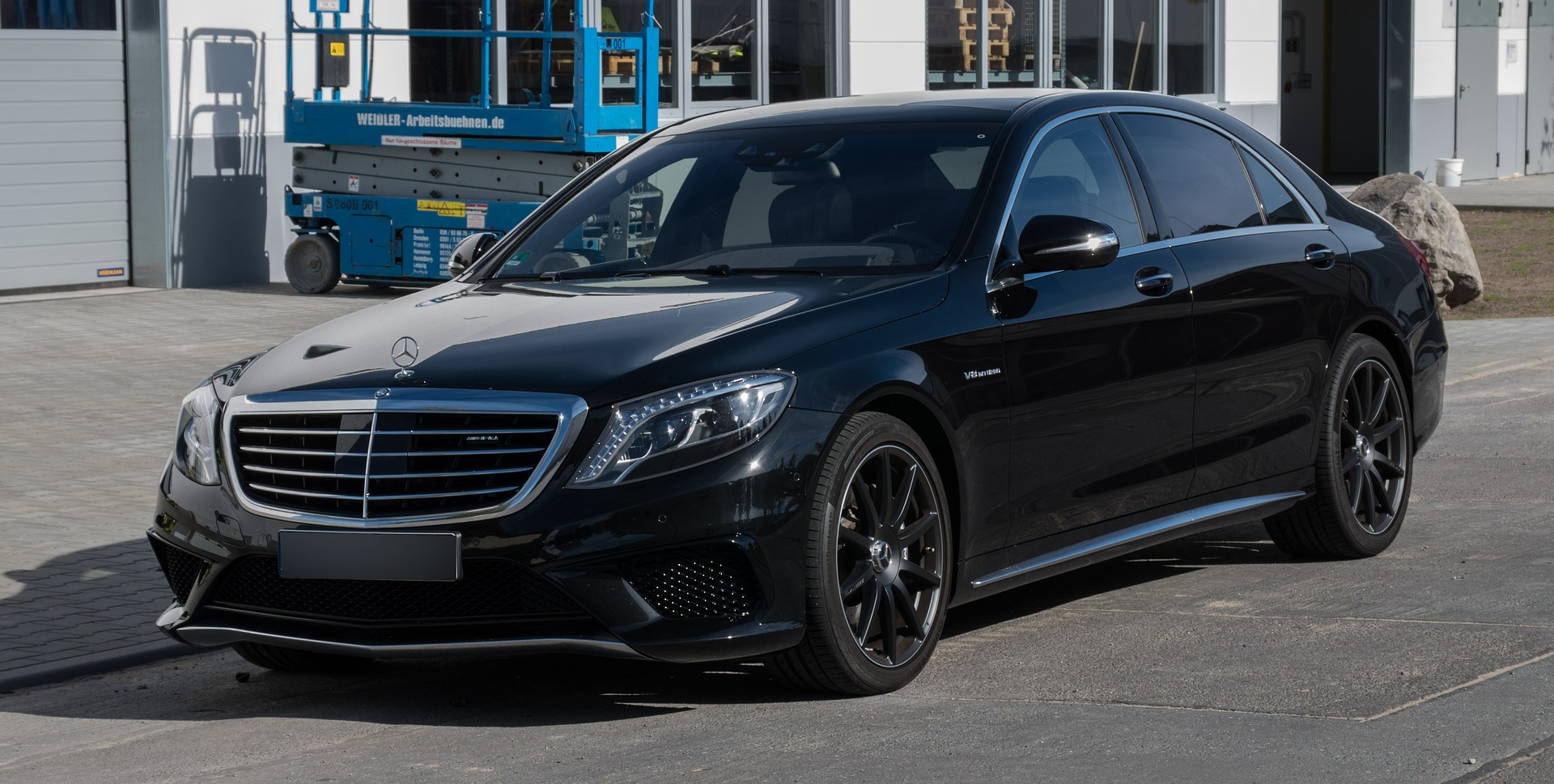 A side profile of a sleek, black Mercedes-Benz S-Class luxury sedan, showcasing the elite vehicle options available for Orlux Premium Chauffeur Services.
