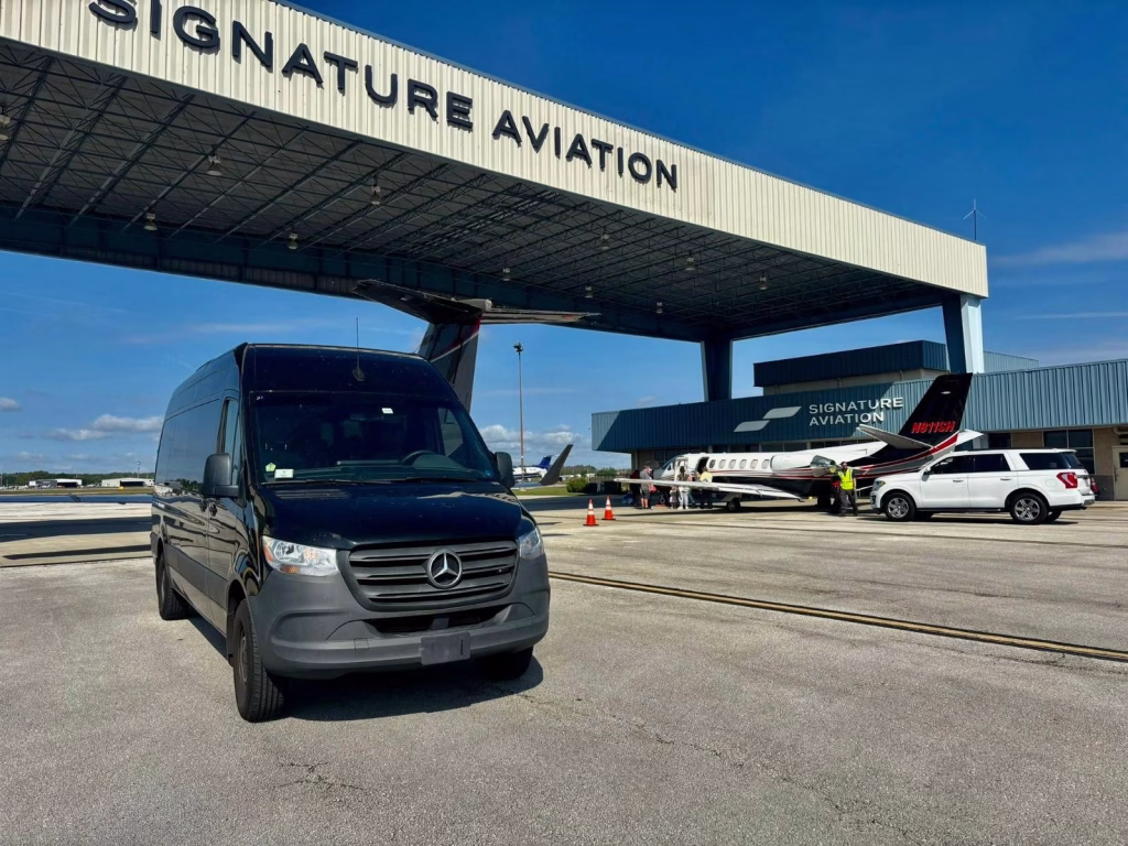 Which Sprinter Van Is Right for You? The Complete Guide to All Four Sprinter Options 20 Black Mercedes-Benz Sprinter van parked on an airport apron outside a private-jet terminal
