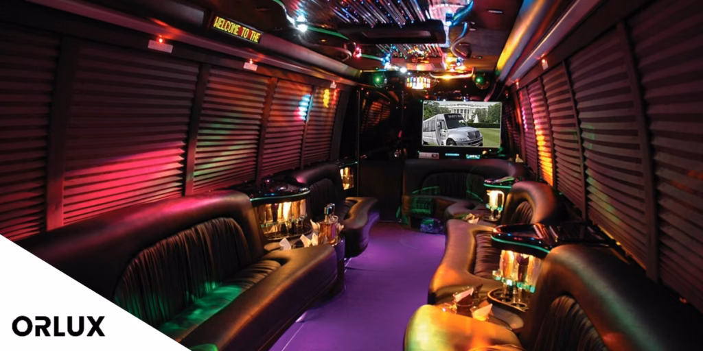 Party Bus Prices in Orlando: A Clear 2026 Cost Guide & Comparison 10 Interior of a large party bus with wraparound leather seating, a bar and colored lighting