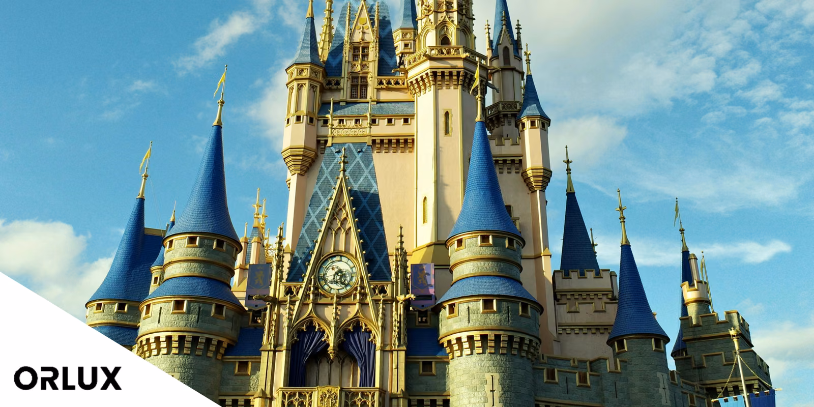 Cinderella Castle's blue spires and gold trim against a bright sky at Walt Disney World